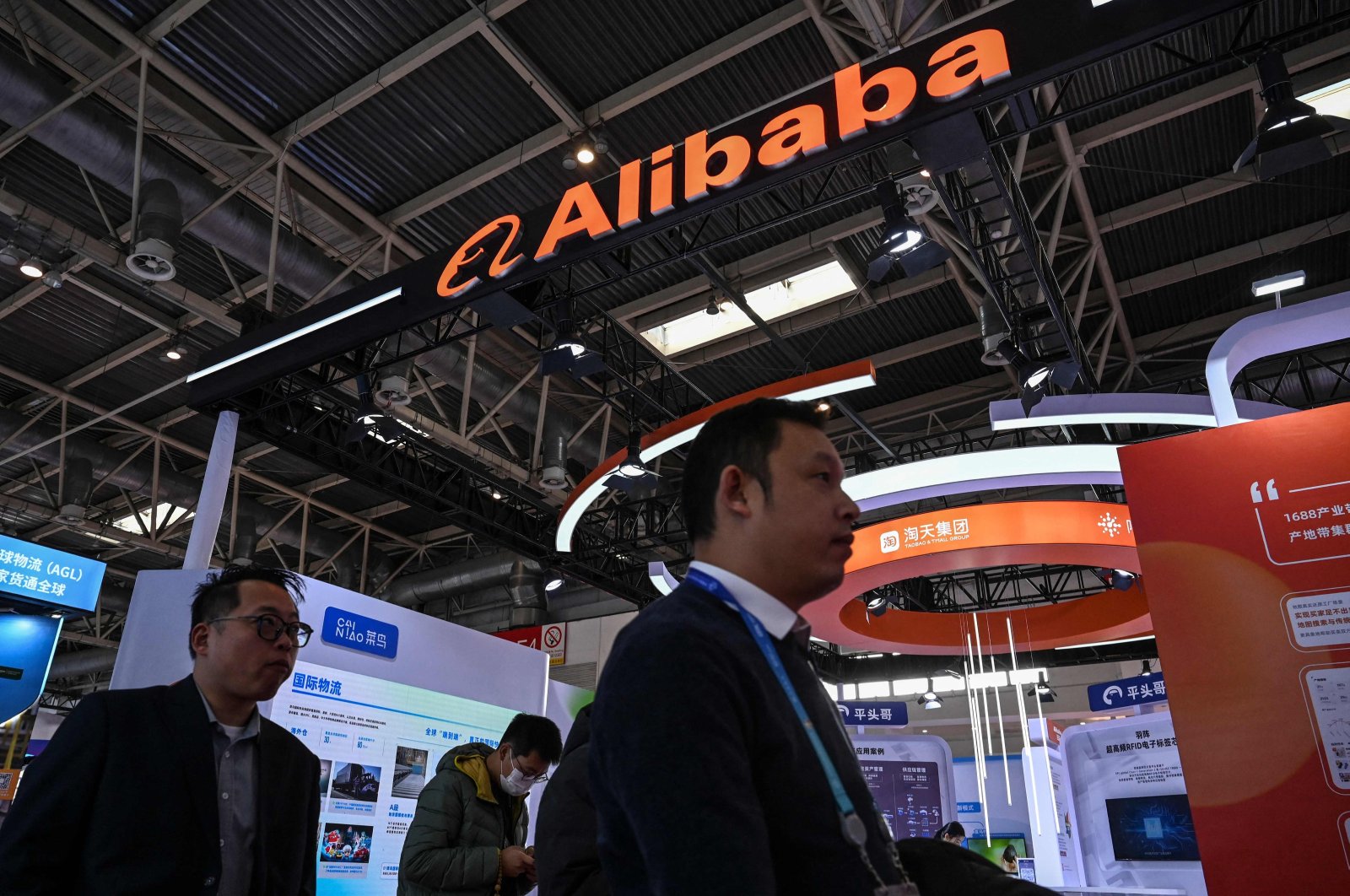 People walk past an Alibaba booth during the China International Supply Chain Expo (CISCE) in Beijing, China, Dec. 1, 2023. (AFP Photo)