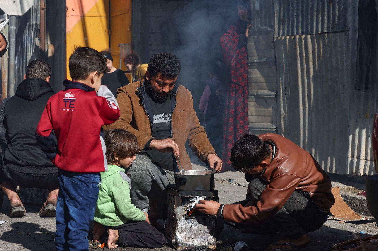 Internally displaced Palestinians cook in the street, near their temporary shelter, Rafah, southern Gaza, Palestine, Dec. 9, 2023. (AFP Photo)