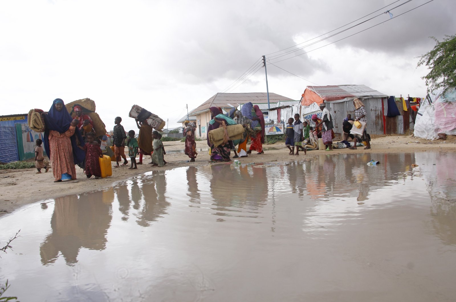 Displaced Somali vacate their camps after heavy floods entered their makeshift shelter in Mogadishu, Somalia, Nov.13, 2023. (AP Photo)