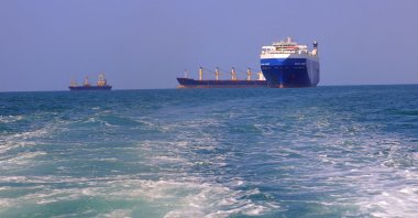 A picture taken during an organized tour by Yemen&#039;s Houthi rebels on Nov.22, 2023, shows the Galaxy Leader cargo ship (R), seized by Houthis two days earlier, approaching the port in the Red Sea off Yemen&#039;s province of Hodeida. (AFP Photo)
