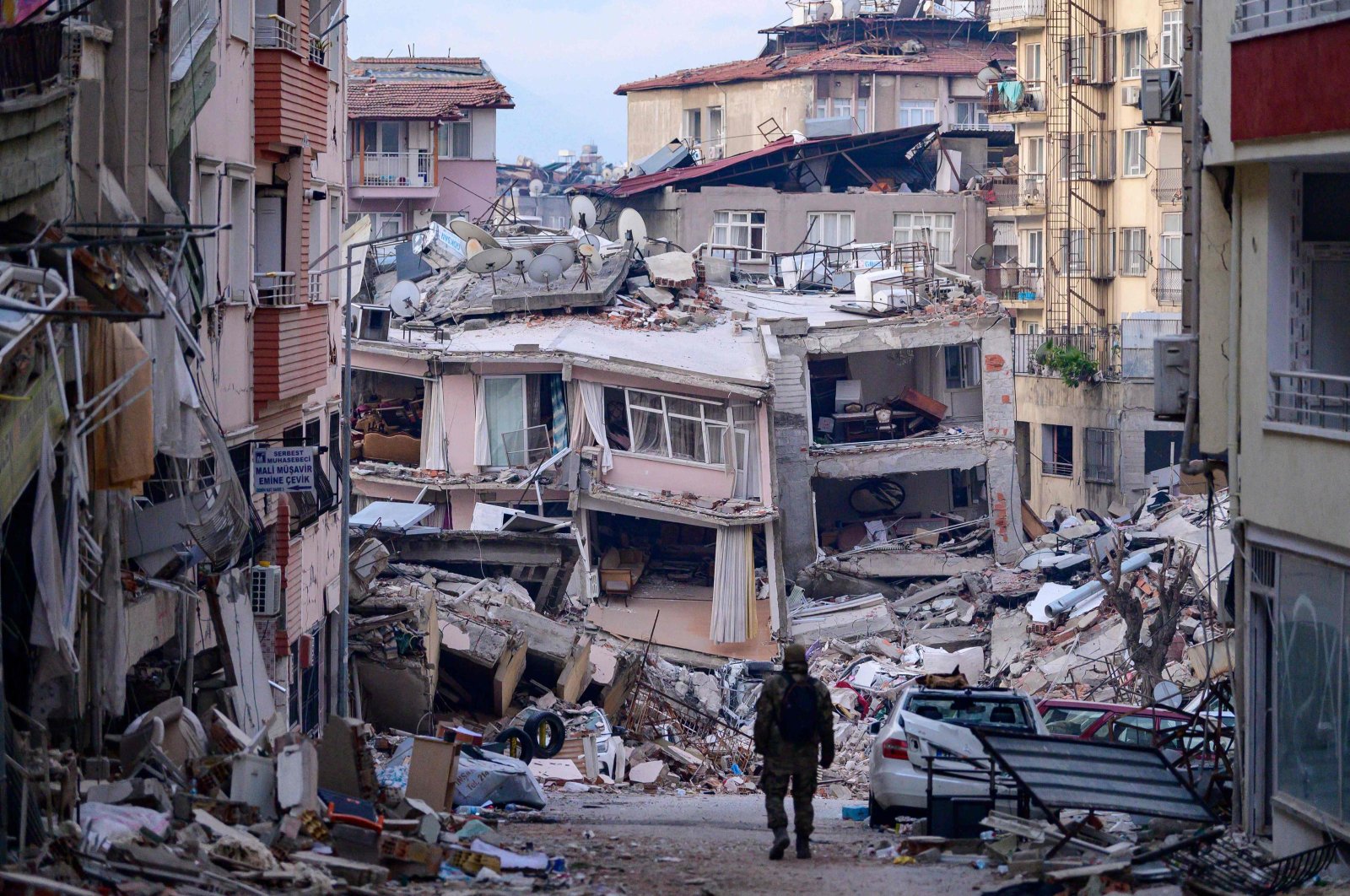 A Turkish soldier walks among destroyed buildings after the Feb. 6 earthquakes struck the country&#039;s southeast causing widespread damage, in Hatay, Türkiye, Feb. 12, 2023. (AFP Photo)