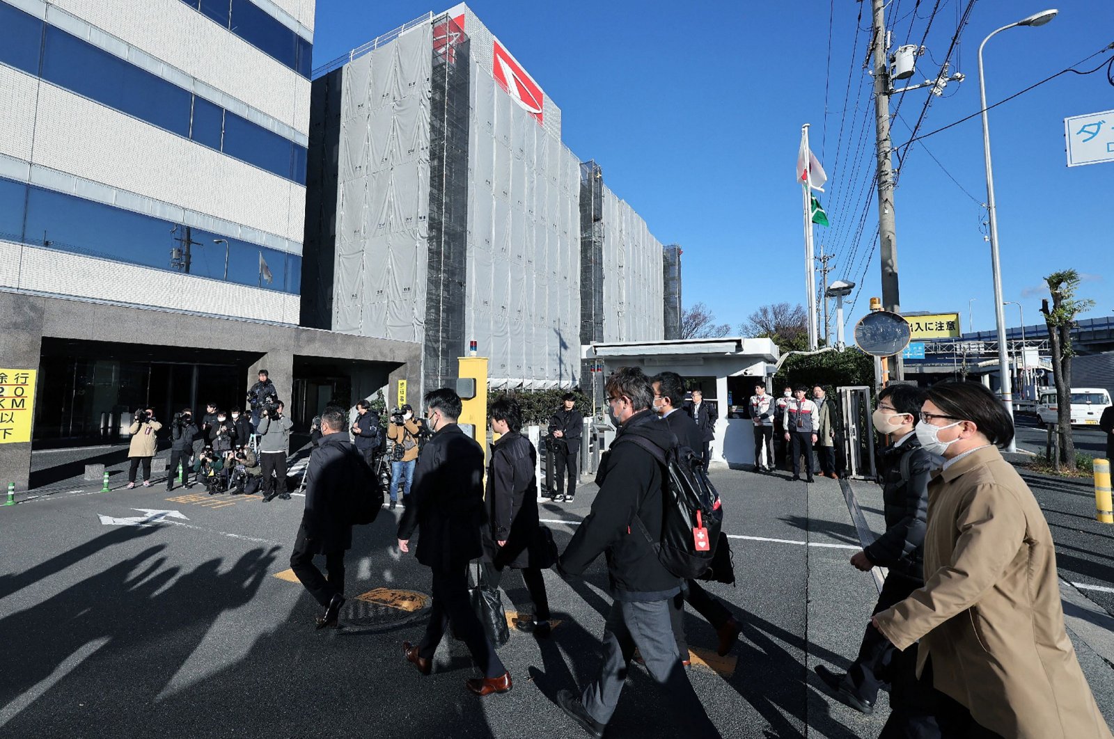 Officials from Japan&#039;s Ministry of Land, Infrastructure, Transport and Tourism enter the Daihatsu Motor headquarters for inspection work in Ikeda, Osaka Prefecture, Japan, Dec. 21, 2023. (AFP Photo)