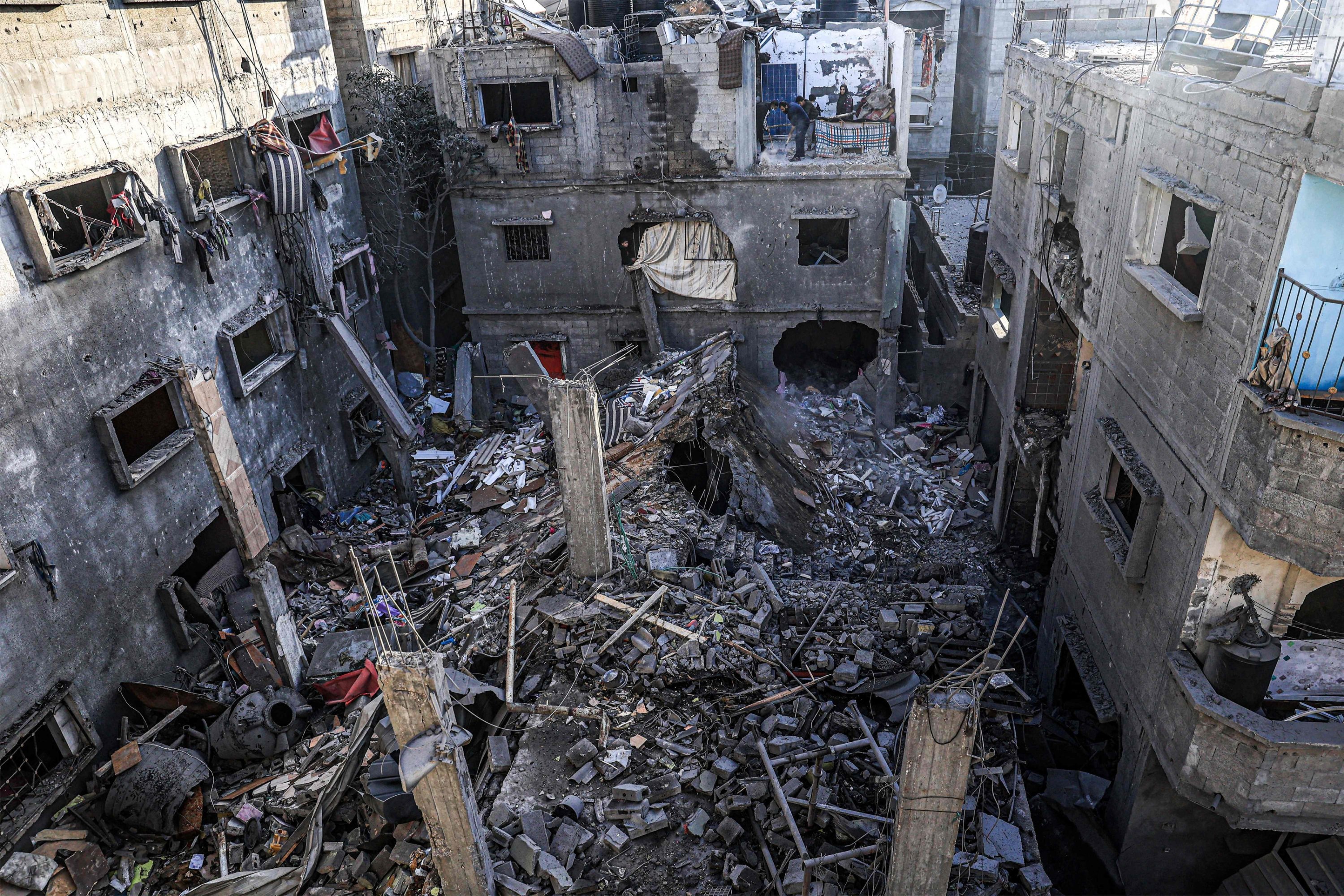 People inspect the rubble of a building destroyed by Israeli bombardment in Rafah in the southern Gaza Strip, Palestine, Dec. 24, 2023. (AFP Photo)