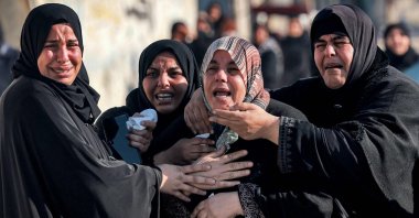 Women tend to the sister (C) of Palestinian journalist Adel Zorob, who was killed in an Israeli attack in Rafah, southern Gaza, Palestine, Dec. 19, 2023. (AFP Photo)