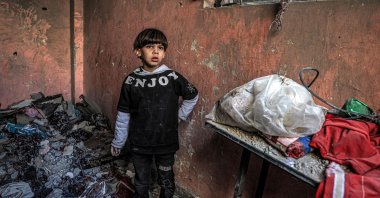 A child stands by the rubble of a building destroyed by Israeli bombardment, Rafah, southern Gaza Strip, Palestine, Dec. 24, 2023. (AFP Photo)