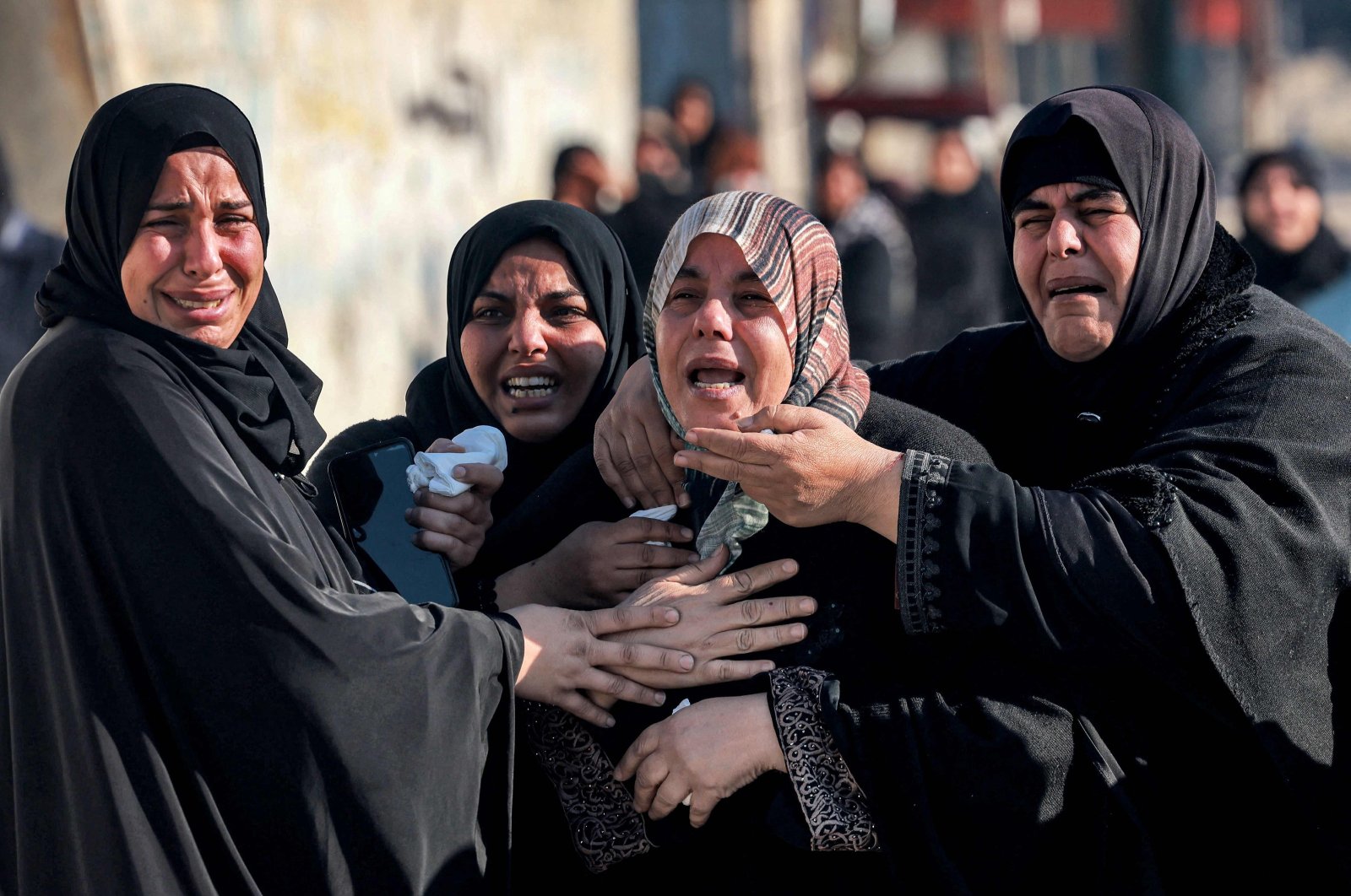Women tend to the sister (C) of Palestinian journalist Adel Zorob, who was killed in an Israeli attack in Rafah, southern Gaza, Palestine, Dec. 19, 2023. (AFP Photo)