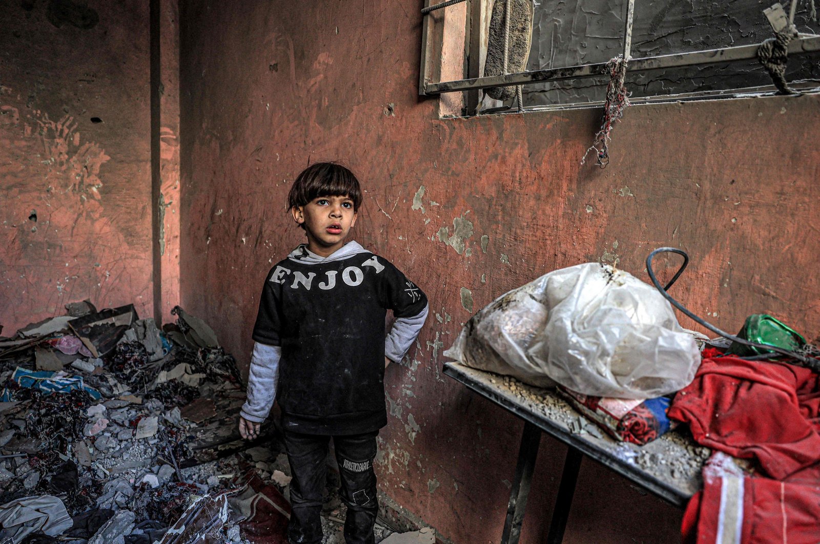 A child stands by the rubble of a building destroyed by Israeli bombardment, Rafah, southern Gaza Strip, Palestine, Dec. 24, 2023. (AFP Photo)