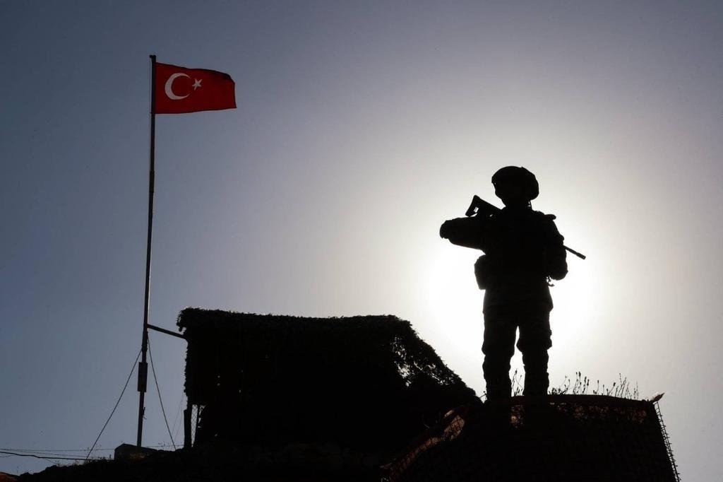 This handout photo by the Turkish Defense Ministry shows a soldier standing watch on an outpost along the Turkish border in an unknown location. (DHA Photo)