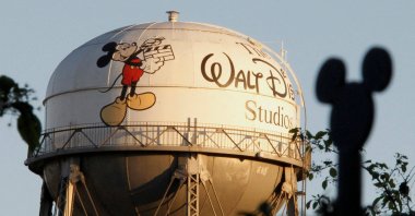 The water tower at The Walt Disney Co., featuring the character Mickey Mouse, is seen behind a silhouette of mouse ears on the fencing surrounding the company&#039;s headquarters in Burbank, California, U.S., Feb. 7, 2011. (Reuters Photo)