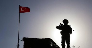 This handout photo by the Turkish Defense Ministry shows a soldier standing watch on an outpost along the Turkish border in an unknown location. (DHA Photo)