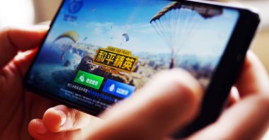 A Chinese mobile game player plays Tencent's "Game for Peace" on his smartphone in Jinan city, Shandong province, China, May 8, 2019. (Reuters Photo)
