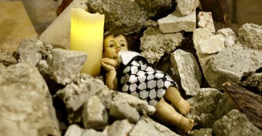 An installation shows a figure symbolizing baby Jesus lying amidst the rubble in a reference to Gaza, Bethlehem, occupied West Bank, Palestine, Dec. 24, 2023. (Reuters Photo)