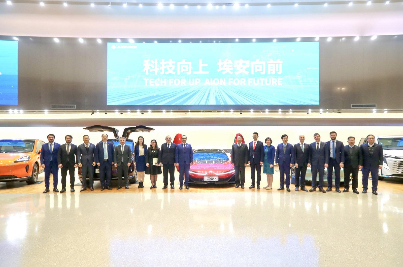 Industry and Technology Minister Mehmet Fatih Kacır (C-L) and other officials and executives pose for a photo during a visit to Chinese carmaker GAC, in Guangzhou, China, Dec. 23, 2023. (AA Photo)