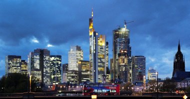 A double-decker bus passes the skyline with its dominating banking district in Frankfurt, Germany, Nov. 8, 2023. (Reuters Photo)