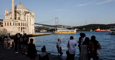 Tourists enjoy the shore of the Bosporus in the Ortaköy neighborhood of Istanbul, Türkiye, May 26, 2021. (Reuters Photo)