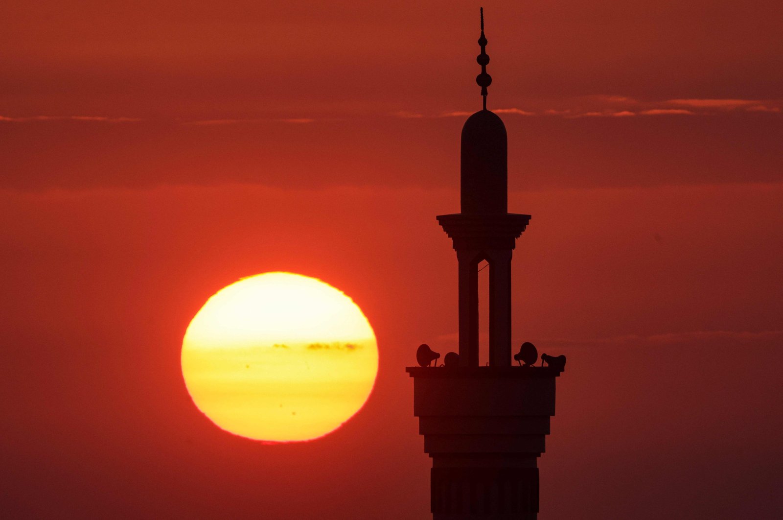 The sun sets behind a mosque minaret in Rafah in the southern Gaza Strip, Palestine, Dec. 25, 2023. (AFP Photo)