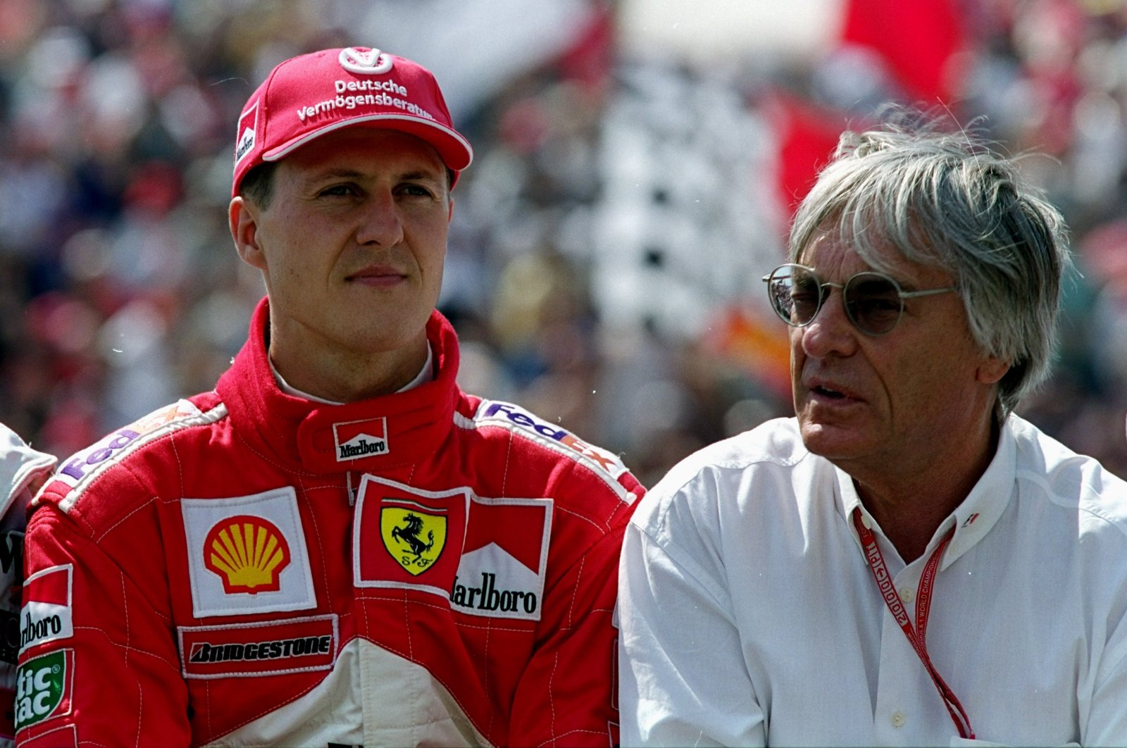 Ferrari driver Michael Schumacher (L) with Bernie Ecclestone before the Formula One Hungarian Grand Prix at the Hungaroring, Budapest, Hungary, Aug. 13, 2000. (Getty Images Photo)