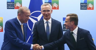 President Recep Tayyip Erdoğan (L) shakes hands with Sweden's Prime Minister Ulf Kristersson (R) as NATO Secretary-General Jens Stoltenberg (C) looks on prior to a meeting ahead of a NATO summit in Vilnius, Lithuania, July 10, 2023. (AP Photo)
