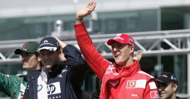 Germany's Michael Schumacher (R) waves with brother Ralf Schumacher during the drivers parade prior to the European F1 Grand Prix, Nurburg, Germany May 30, 2004. (Getty Images Photo)
