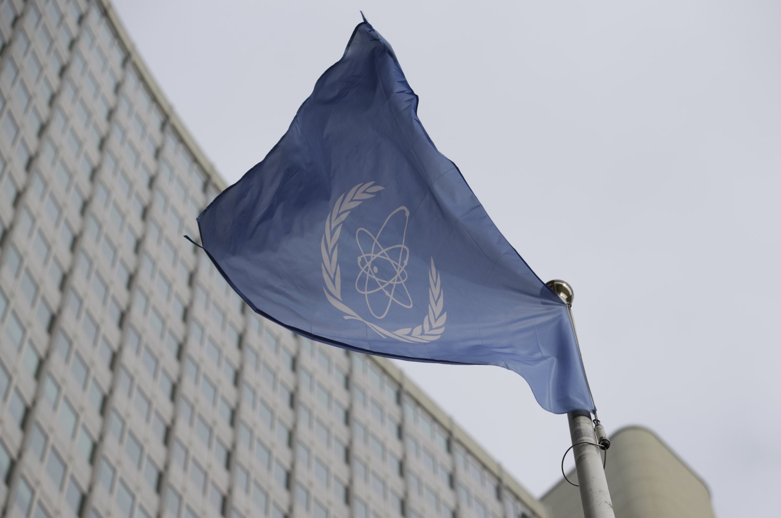 The flag of the IAEA in front of its headquarters in Vienna, Austria, Feb. 6, 2023. (AP Photo)