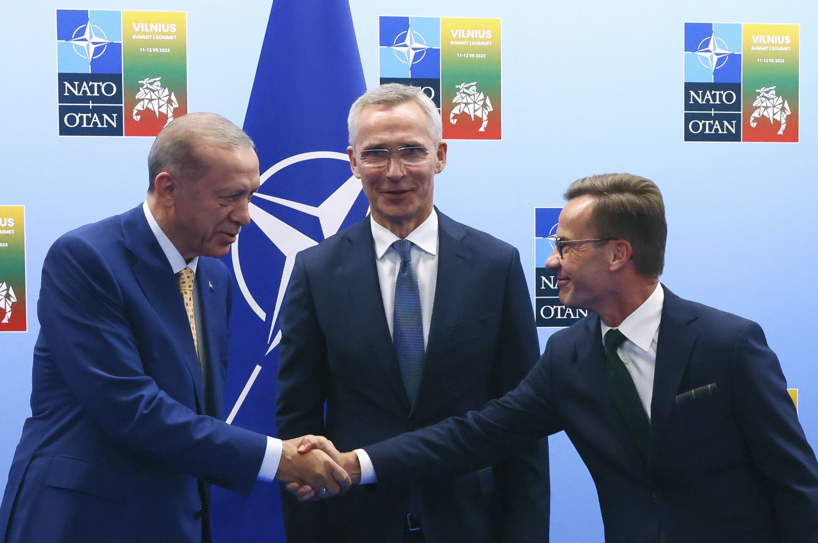 President Recep Tayyip Erdoğan (L) shakes hands with Sweden&#039;s Prime Minister Ulf Kristersson (R) as NATO Secretary-General Jens Stoltenberg (C) looks on prior to a meeting ahead of a NATO summit in Vilnius, Lithuania, July 10, 2023. (AP Photo)