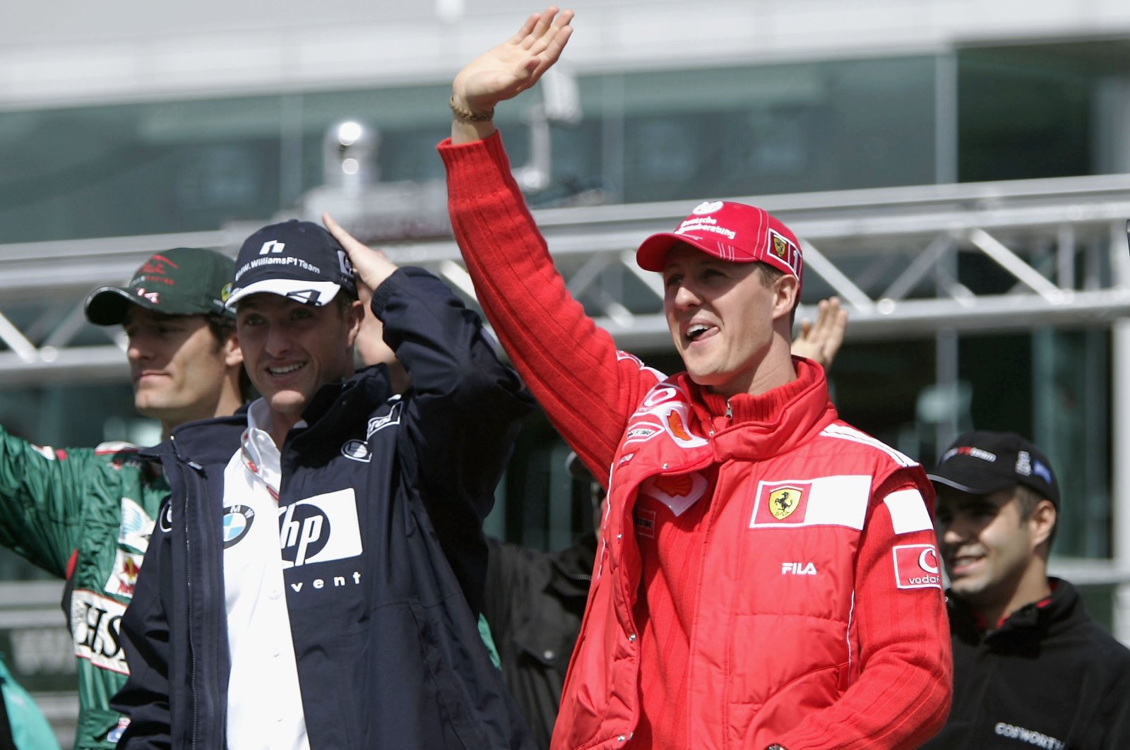 Germany&#039;s Michael Schumacher (R) waves with brother Ralf Schumacher during the drivers parade prior to the European F1 Grand Prix, Nurburg, Germany May 30, 2004. (Getty Images Photo)