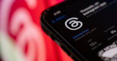 This photo illustration shows Threads, an Instagram app, on the App Store, in front of the logos of Instagram and Threads, Washington, DC, U.S., July 5, 2023. (AFP Photo)