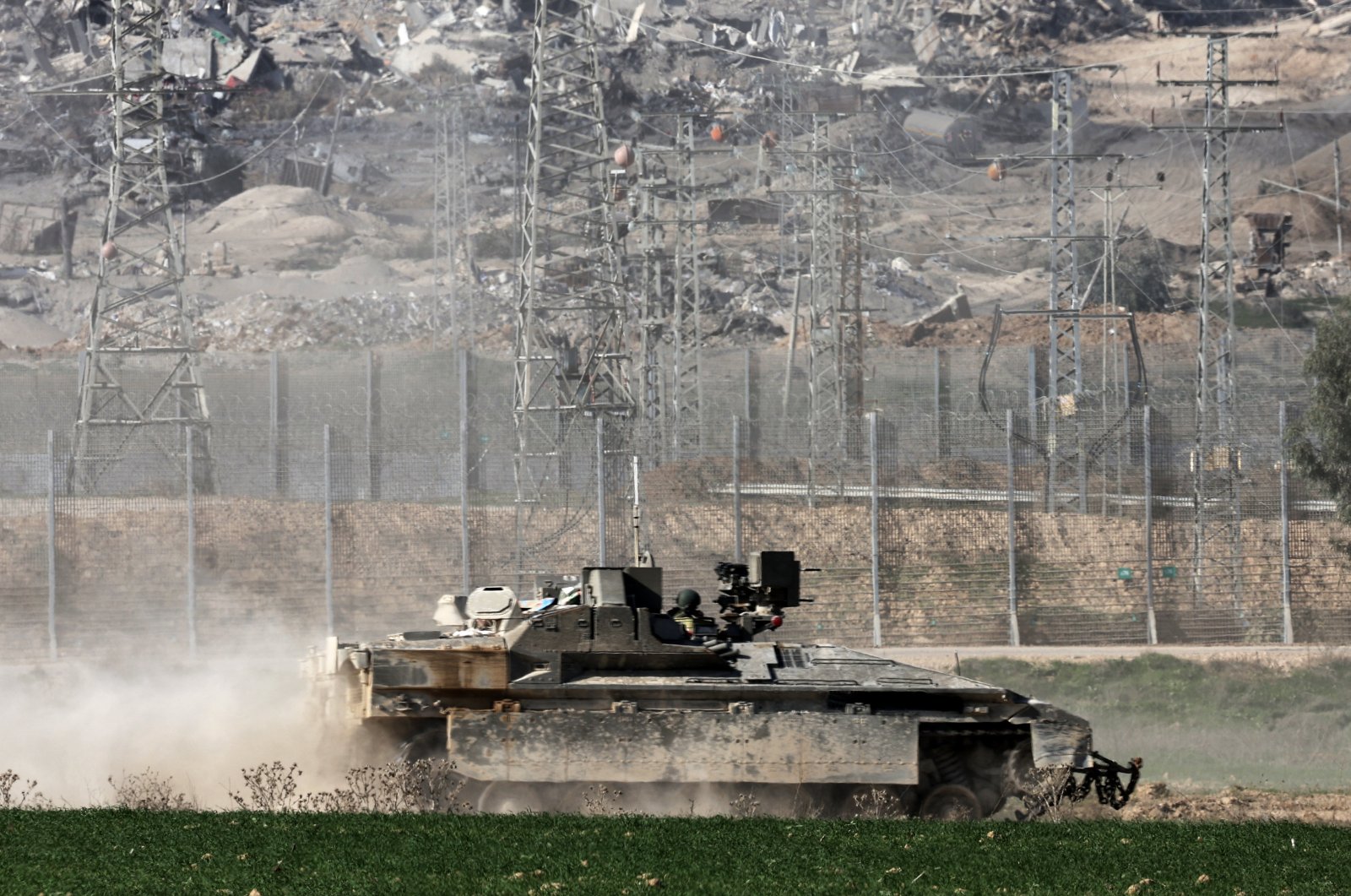 An Israeli armored personnel carrier (APC) patrols near the Israeli-Gaza border, overlooking the Shujaiya neighborhood in the Gaza Strip, Dec. 29, 2023. (EPA Photo)