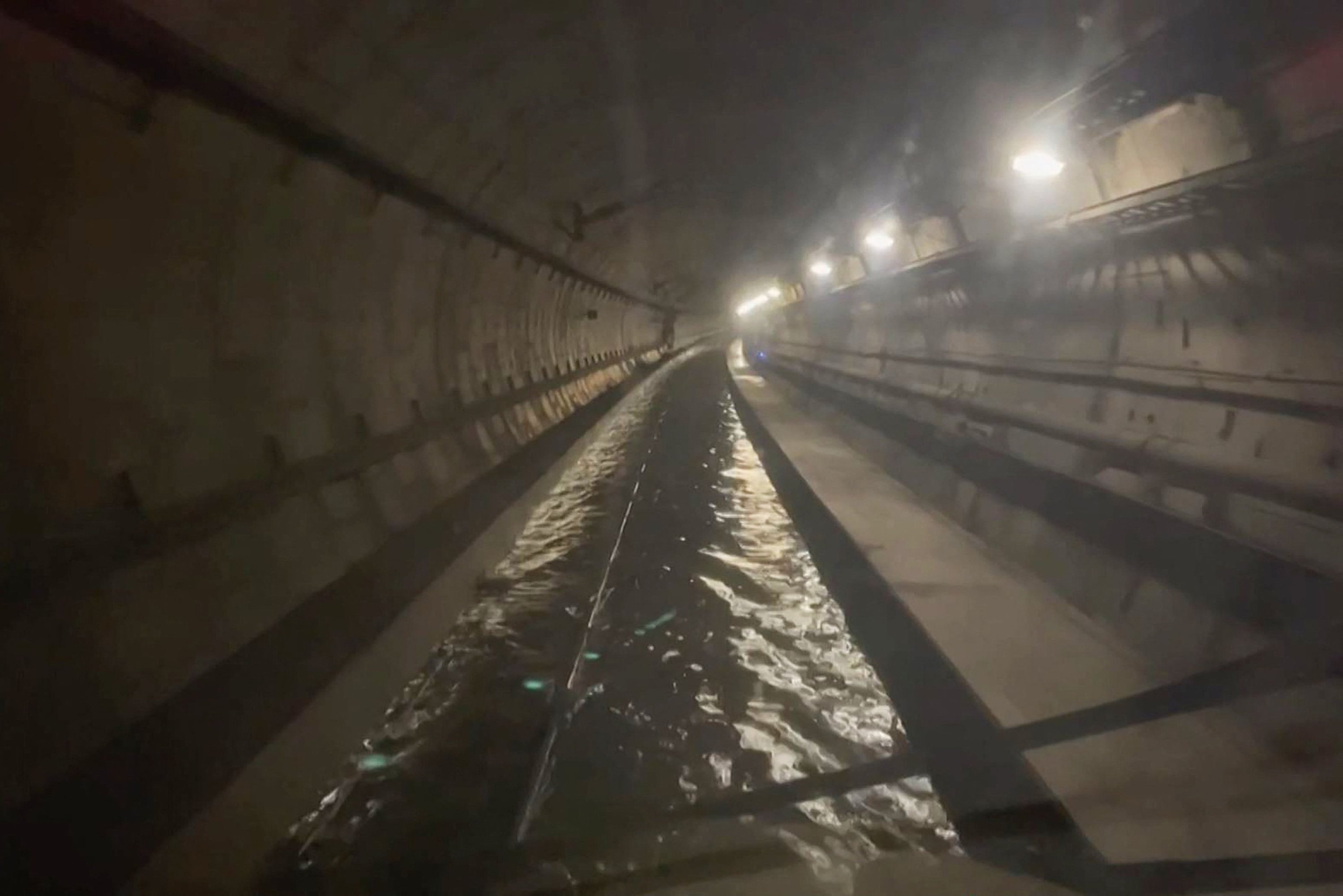 A frame grab taken from a handout video footage posted on the Southeastern Railway's X account on Dec. 30, 2023  shows flooded water in a tunnel used by Eurostar trains, near Ebbsfleet International station in Kent, southern England. (AFP Photo via Southeastern ESN)