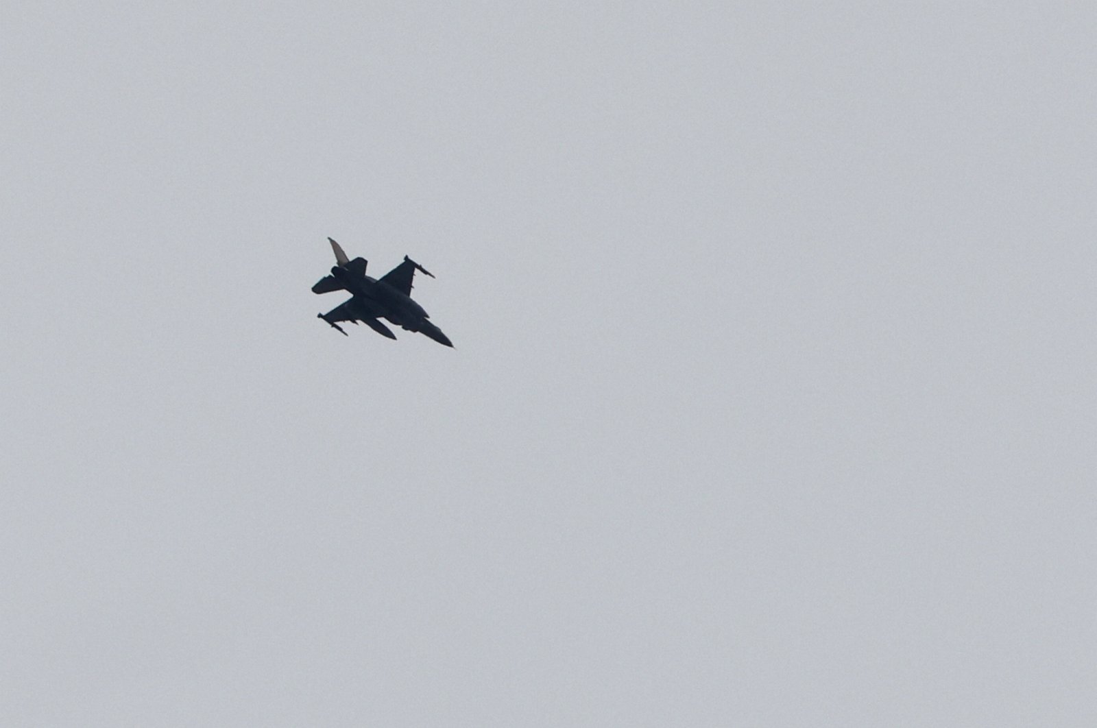 A picture taken from southern Israel near the border with the Gaza Strip on Dec. 21, 2023, shows an Israeli jet flying over the Palestinian territory. (AFP File Photo)