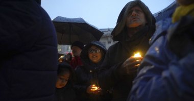People hold candles during a anti-hate vigil on Whitehall, London, Dec. 3, 2023. (AP Photo)