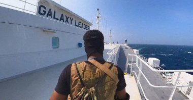A Houthi fighter stands on the Galaxy Leader cargo ship in the Red Sea in this photo released Nov. 20, 2023. (Houthi Military Media/Handout via Reuters)