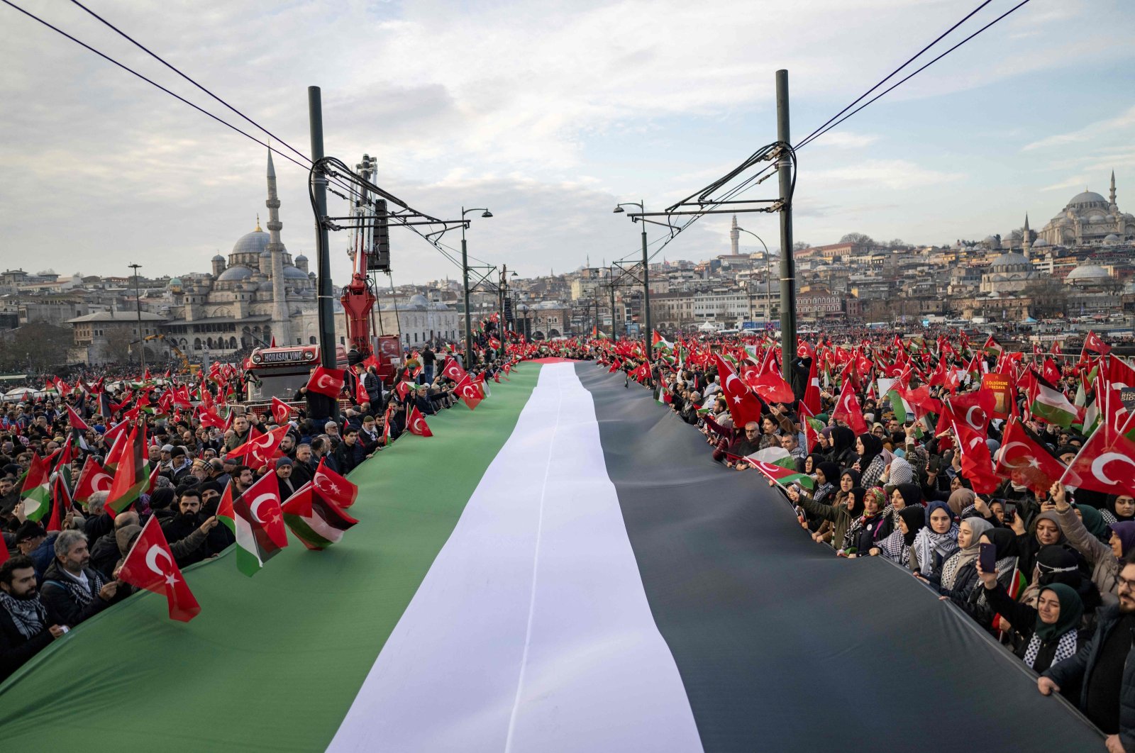 Holding a huge Palestinian flag, thousands demonstrate to show solidarity with the Palestinian people amid Israel&#039;s indiscriminate attacks on the Gaza Strip that have claimed over 20,000 lives, Galata Bridge, Istanbul, Türkiye, Jan 1, 2024. (AFP Photo)