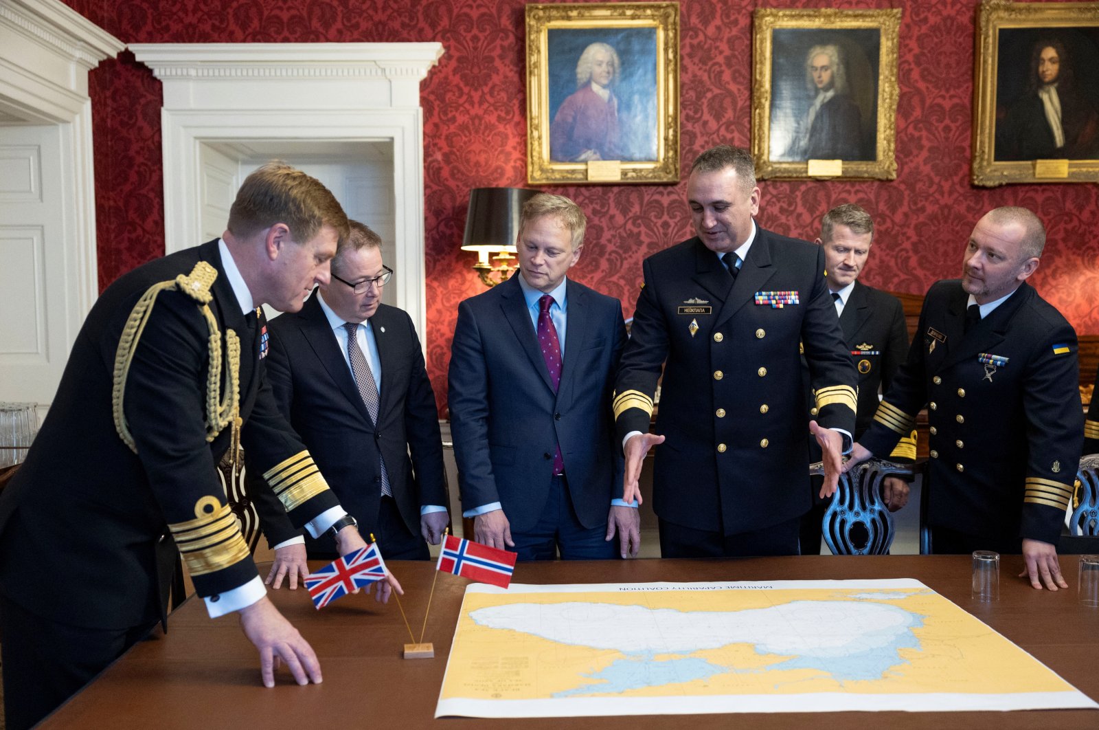 British Defense Minister Grant Shapps meets with Norwegian Defense Minister Bjorn Arild Gram and the Commander of the Ukrainian Navy Oleksiy Neizhpapa, as Britain said it would transfer two Royal Navy minehunter ships to the Ukrainian Navy, as it sets up a new maritime defence coalition alongside Norway, in London, Britain, Dec. 11, 2023. (Rosie Hallam/UK MOD/Handout via Reuters)