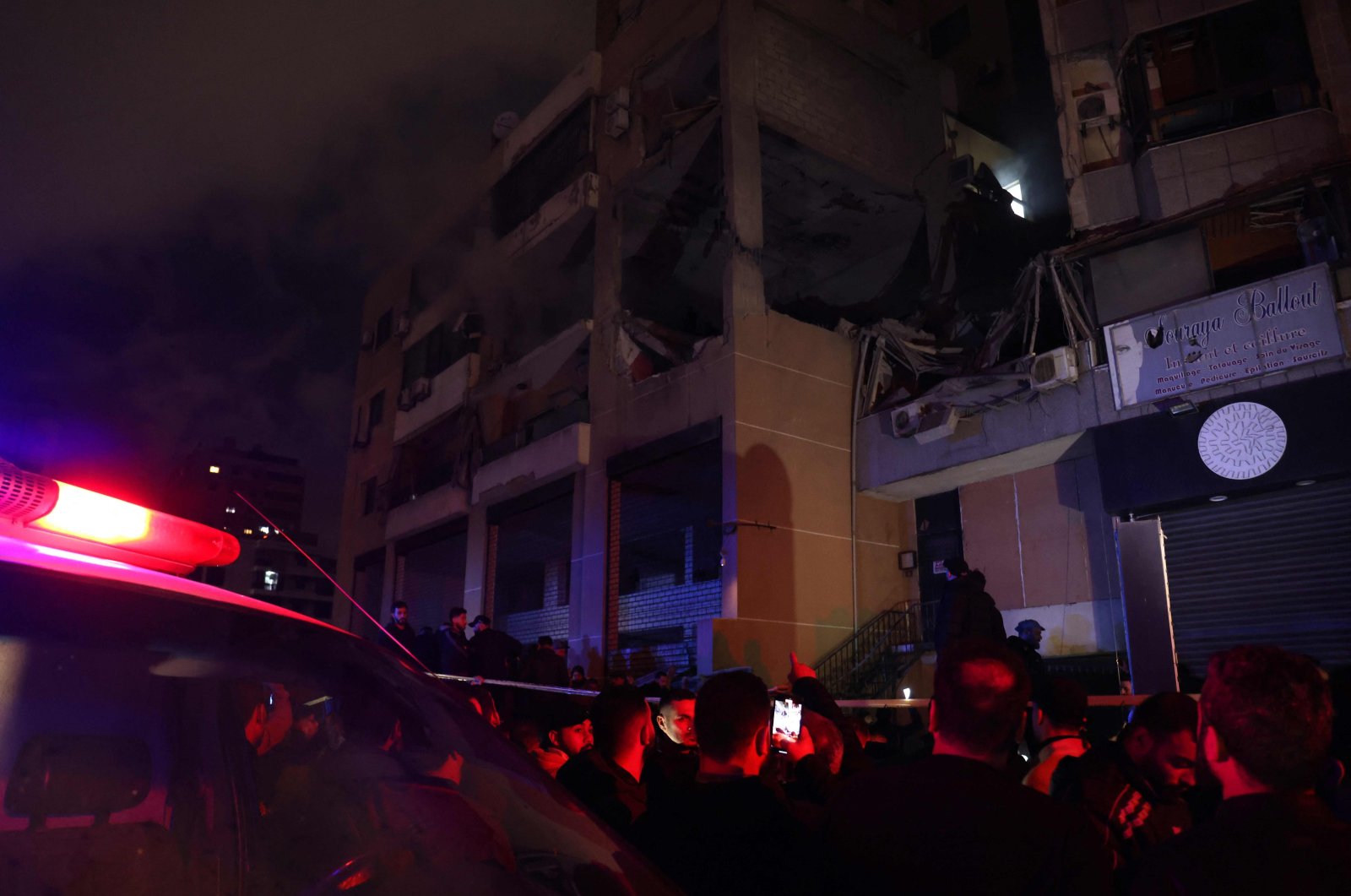 People gather at the site of a strike, reported by Lebanese media to be an Israeli strike targeting a Hamas office, in the southern suburb of Beirut on Jan. 2, 2024. (AFP Photo)