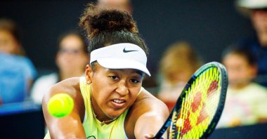 Japan's Naomi Osaka hits a return during her women's singles match against Karolina Pliskova of the Czech Republic at the Brisbane International tennis tournament, Brisbane, Australia, Jan. 3, 2024. (AFP Photo)