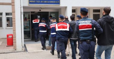 Turkish security forces escort to the gendarmerie headquarters a group of Gülenist Terror Group (FETÖ) suspects caught while trying to flee through the Greek border, in the northwestern Edirne province, Türkiye, Dec. 27, 2023. (IHA Photo)