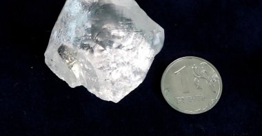 A rough diamond is seen next to a one-rouble coin at the polishing affiliate of Russian diamond producer Alrosa in Moscow, Russia, Feb. 12, 2018. (Reuters Photo)