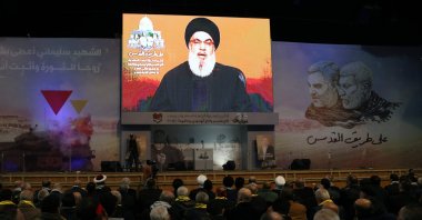 People watch the televised speech of Lebanon's Hezbollah chief Hasan Nasrallah to mark the anniversary of the killing of slain top Iranian commander Qassem Soleimani, in Beirut's southern suburb on Jan. 3, 2024. (AFP Photo)