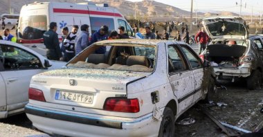 Damaged cars are seen as people try to help victims after an explosion Kerman, Iran, Jan. 3, 2024. (EPA Photo)
