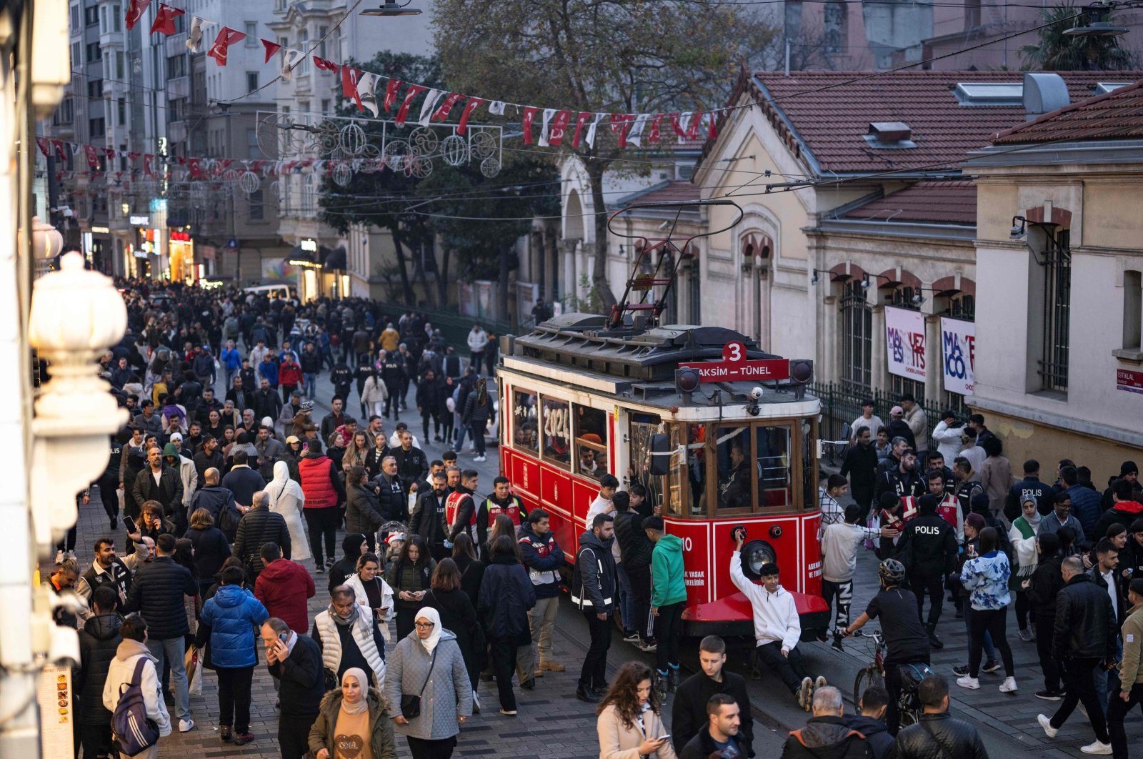 People ride a historical tramway at Taksim Square during preparations to celebrate the new year in Istanbul, Türkiye, Dec. 31, 2023. (AFP Photo)