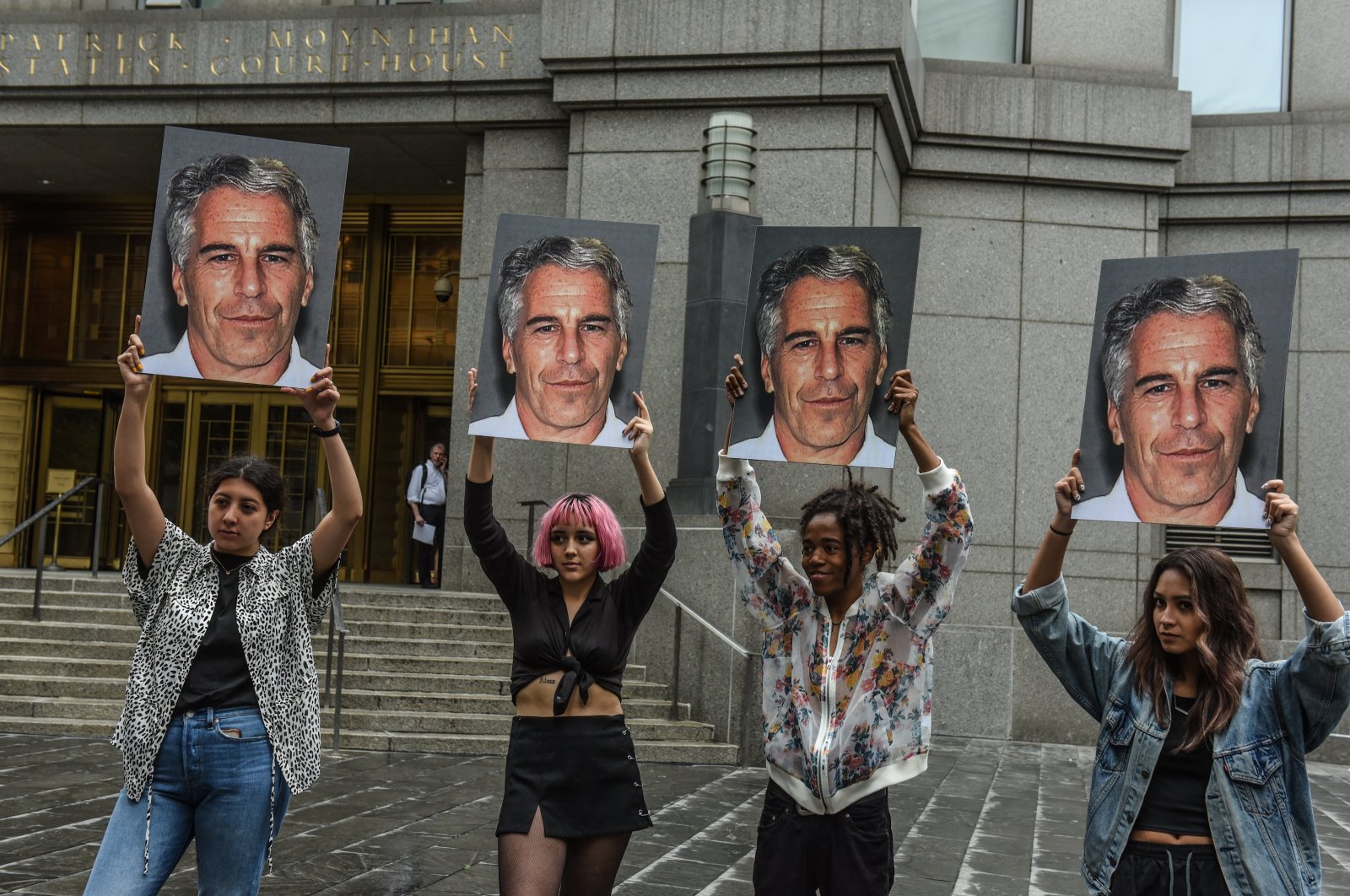 A protest group hold up signs of Jeffrey Epstein in front of the Federal courthouse, in New York City, U.S., July 8, 2019. (Getty Images)