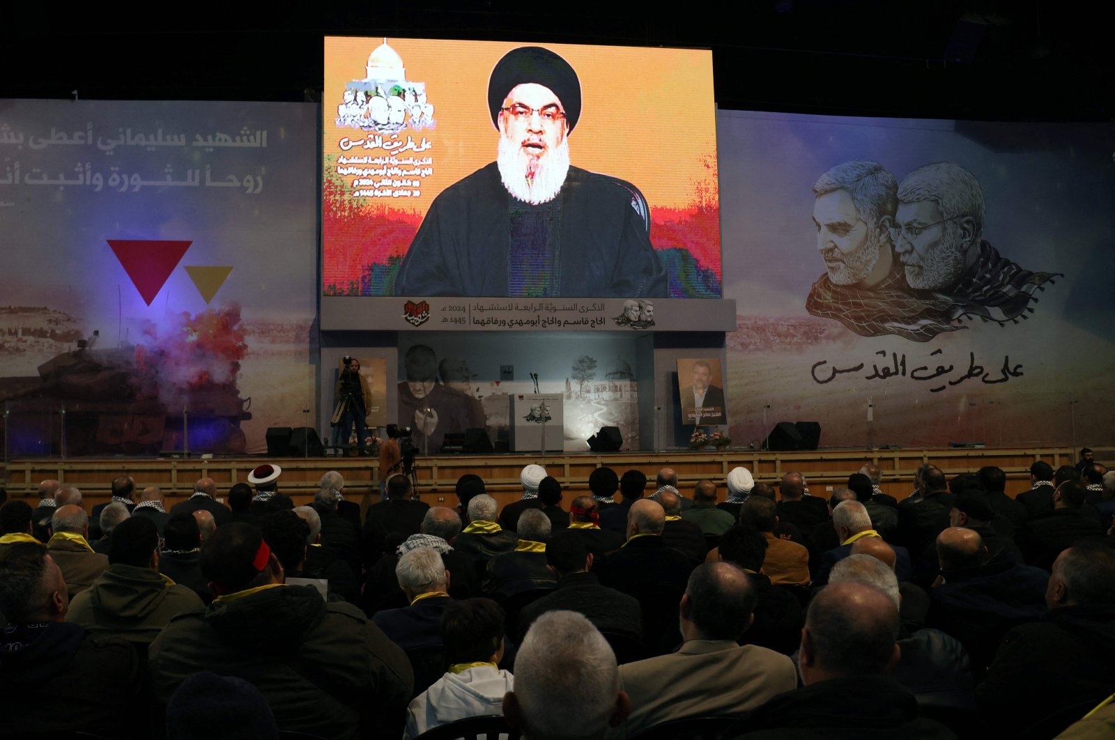 People watch the televised speech of Lebanon&#039;s Hezbollah chief Hasan Nasrallah to mark the anniversary of the killing of slain top Iranian commander Qassem Soleimani, in Beirut&#039;s southern suburb on Jan. 3, 2024. (AFP Photo)
