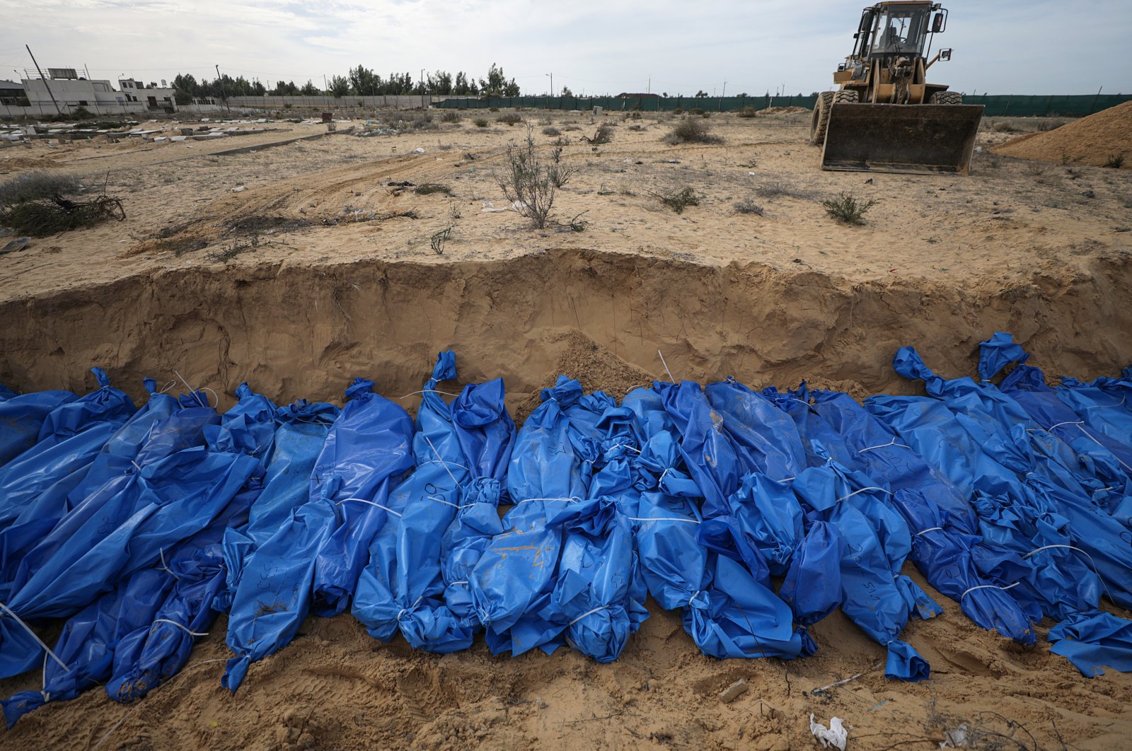 The bodies of 111 Palestinians killed in Israeli strikes on Gaza lie in a mass grave during their burial at the Khan Younis cemetery in the southern Gaza Strip, Palestine, Nov. 22, 2023. (EPA File Photo)