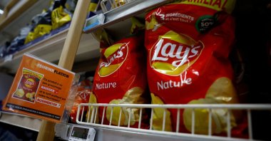 A sign reading "Shrinkflation, This product has seen its weight decrease and the price charged by our supplier increase" at a Carrefour supermarket in Montesson near Paris, France, Sept. 13, 2023. (Reuters Photo)