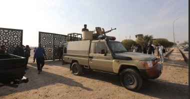 Members of Iraqi Shiite Popular Mobilization Forces (PMF) near a gate after a reported drone strike on a security headquarters in Baghdad, Iraq, Jan. 4, 2024. (EPA Photo)