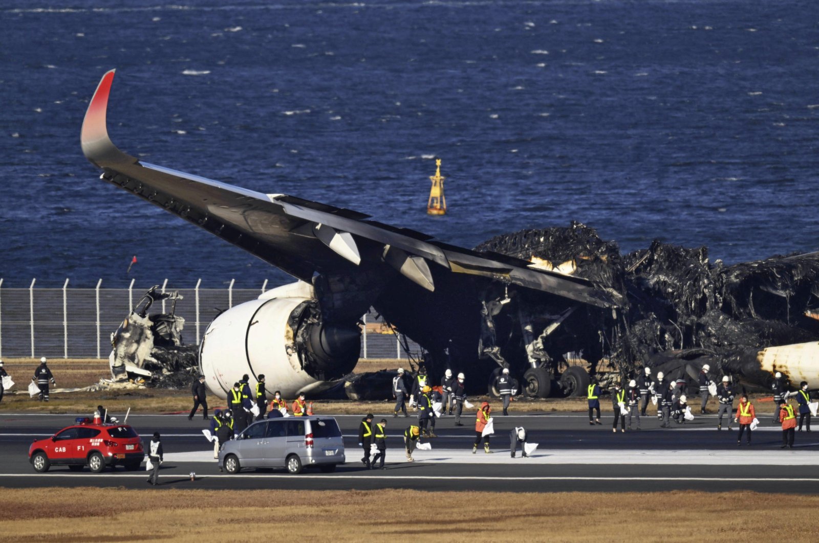 The burned Japan Airlines plane is seen at the Haneda airport in Tokyo, Japan, Jan. 4, 2024. (AP Photo)