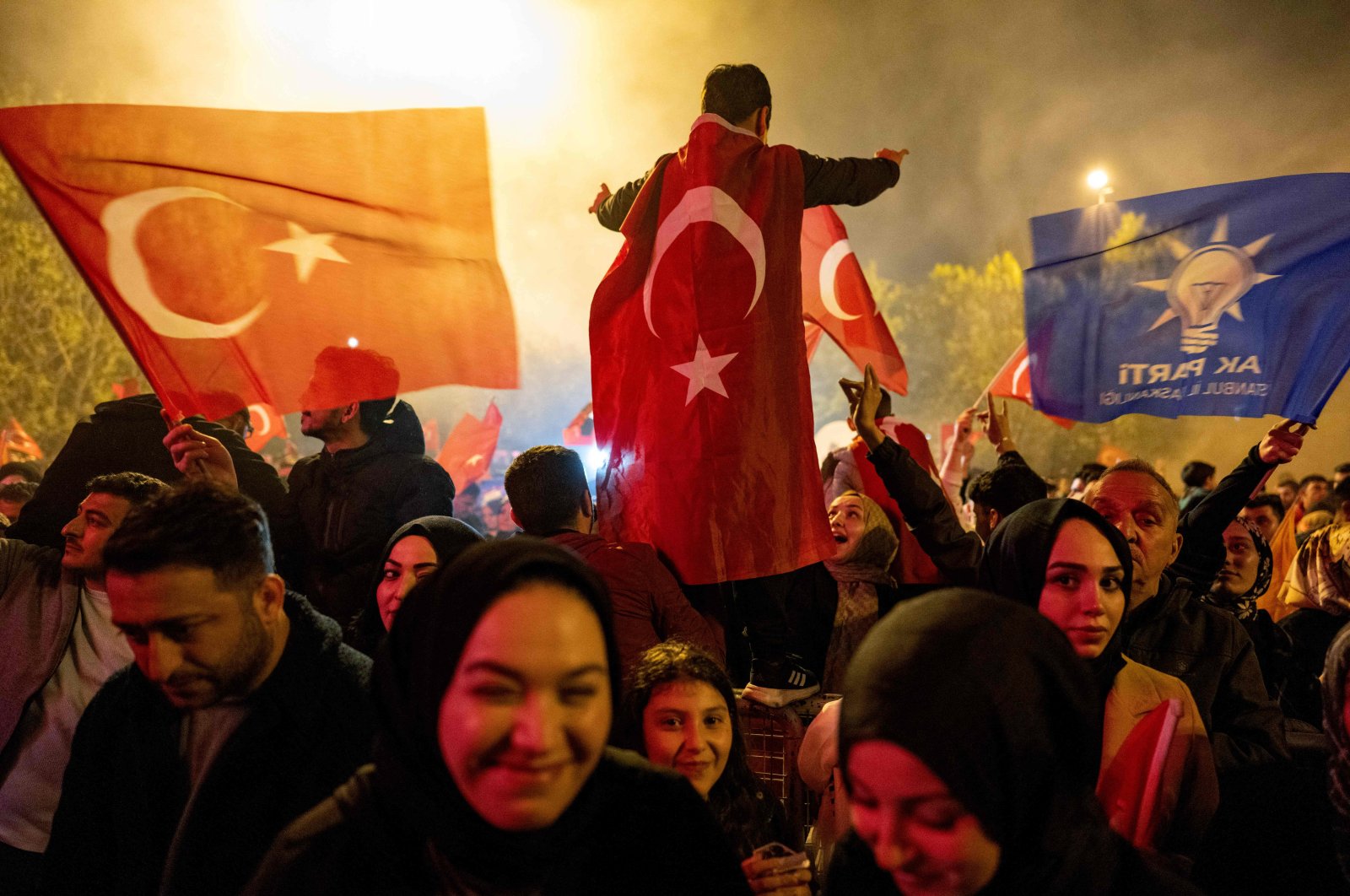 Supporters of President Recep Tayyip Erdoğan wave flags of Türkiye and the Justice and Development Party (AK Party) as they celebrate Erdoğan&#039;s victory in a presidential runoff, Istanbul, Türkiye, May 28, 2023. (AFP Photo)