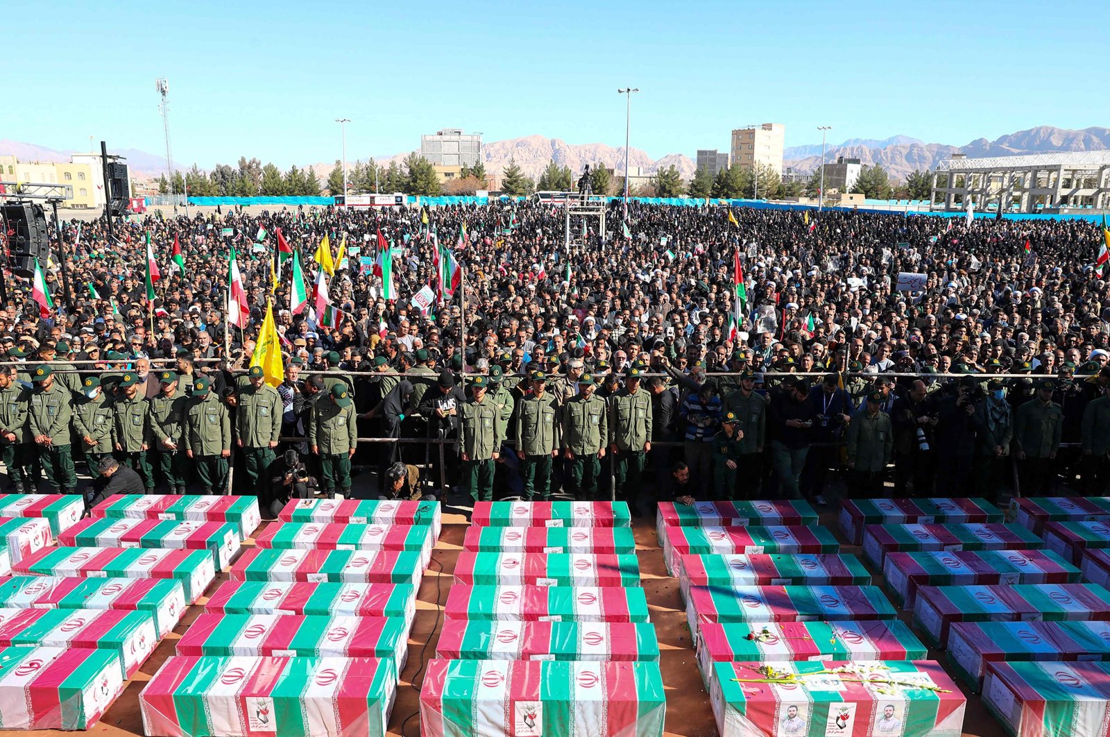 Coffins draped with the Iranian flag during the funeral of victims killed in twin blasts on Jan. 3, as they took part in a commemmoration marking the anniversary of the killing of Revolutionary Guards general Qasem Soleimani in the southern Iranian city of Kerman, Iran, Jan. 5, 2024. (AFP Photo)