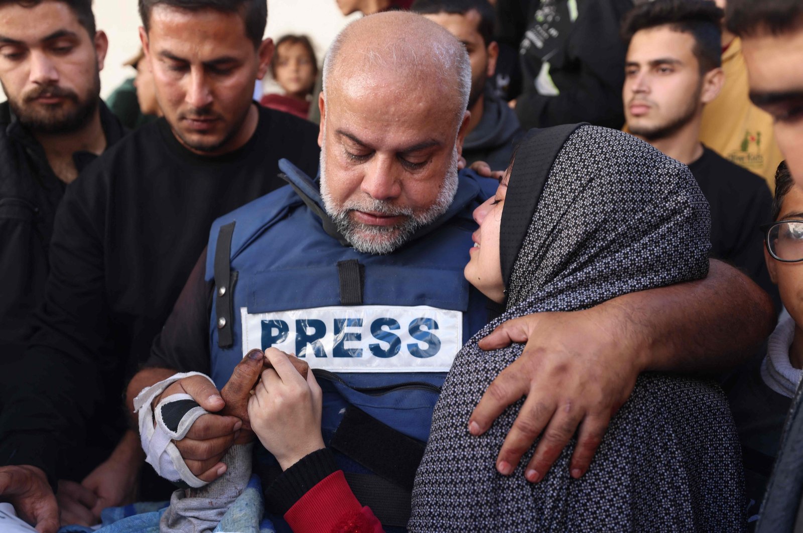 Al Jazeera&#039;s bureau chief in Gaza, Wael al-Dahdouh (C) hugs his daughter during the funeral of his son Hamza Wael al-Dahdouh, a journalist with the Al Jazeera television network, who was killed in a reported Israeli airstrike in Rafah, Gaza Strip, Palestine, Jan. 7, 2024. (AFP Photo)